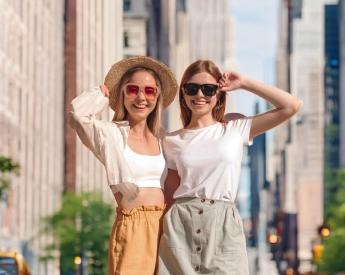 Fashionable young women posing in summer outfits in NYC.