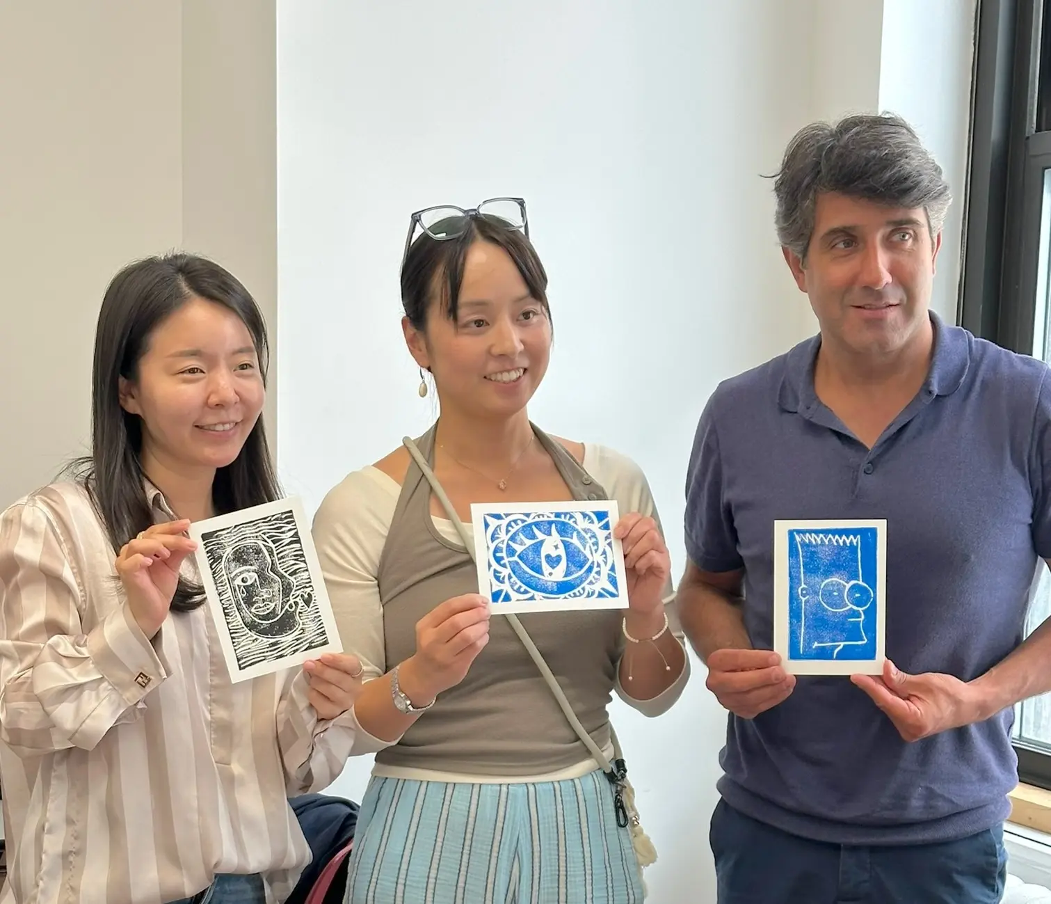 Rennert students displaying their finished printmaking artwork after a hands-on creative workshop in New York City.